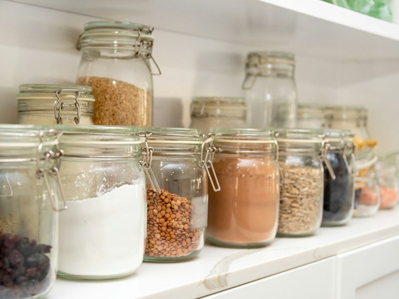A row of jars filled with different types of food
